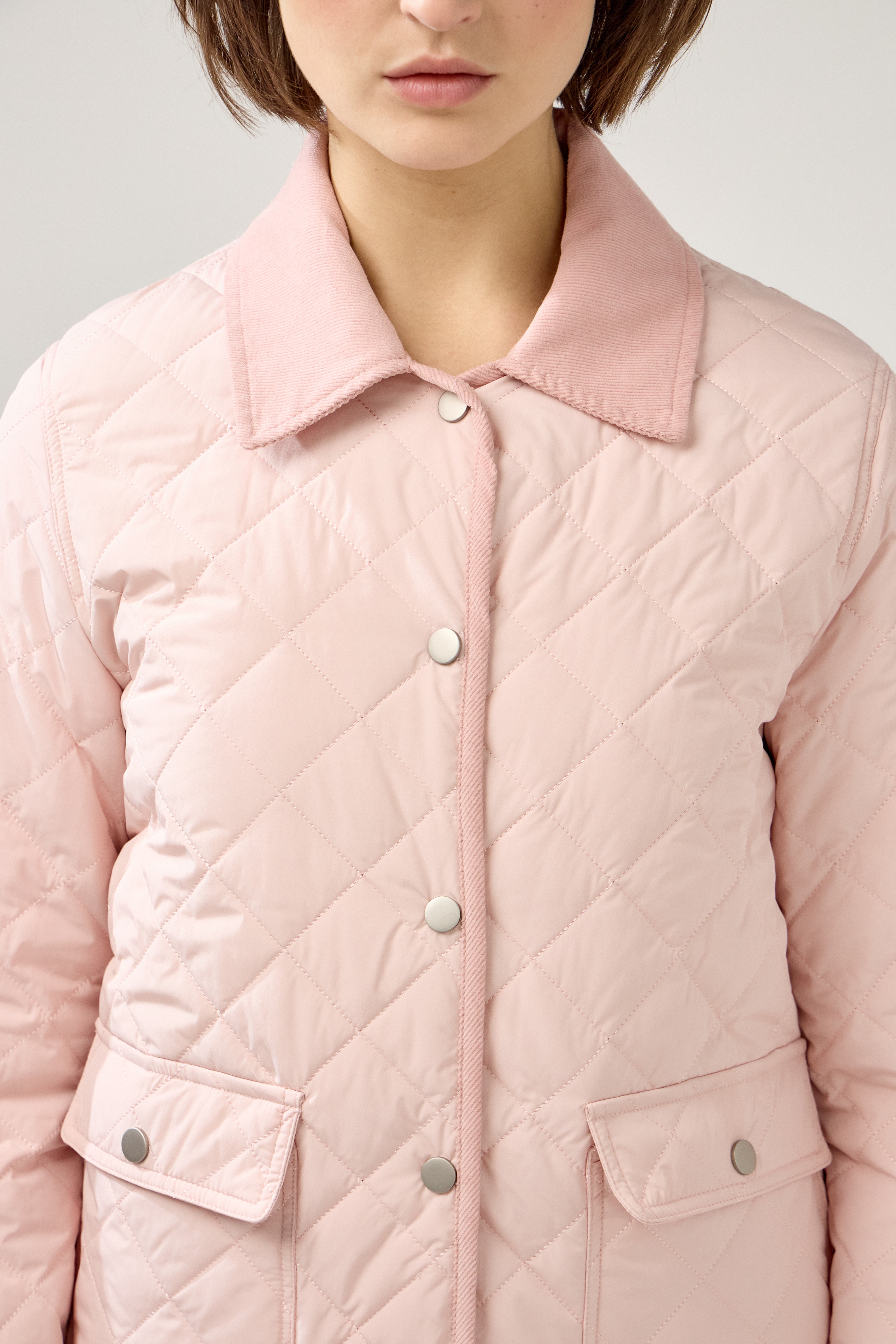 veste matelassée boutonnées, bi-matière, col français, poches plaquées à rabats et bouton pression, zoom devant
#couleur_rose