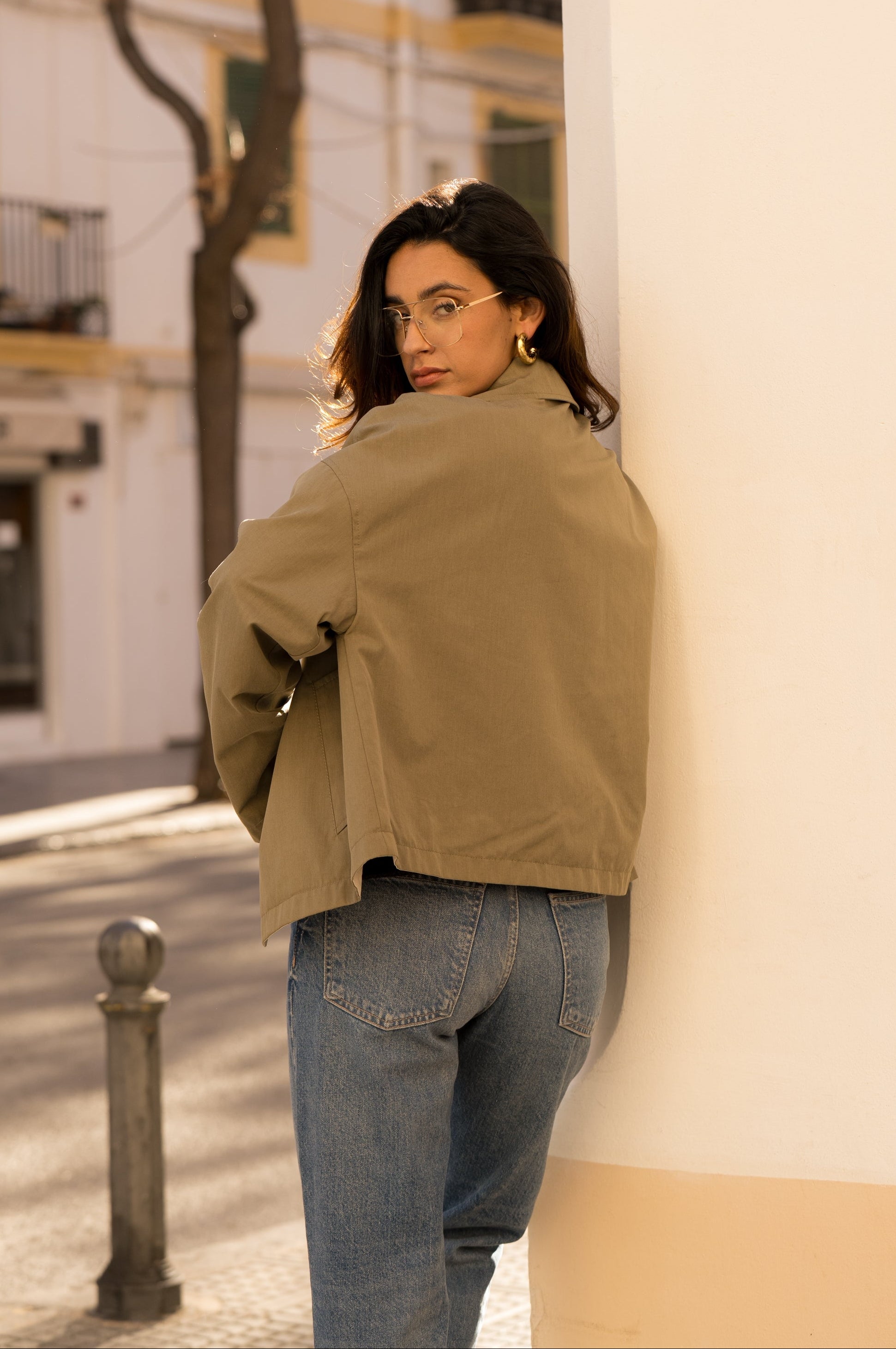 femme portant un veste style trench réversible imperméable, fermeture à boutons, poches et col français, dos
#couleur_kaki